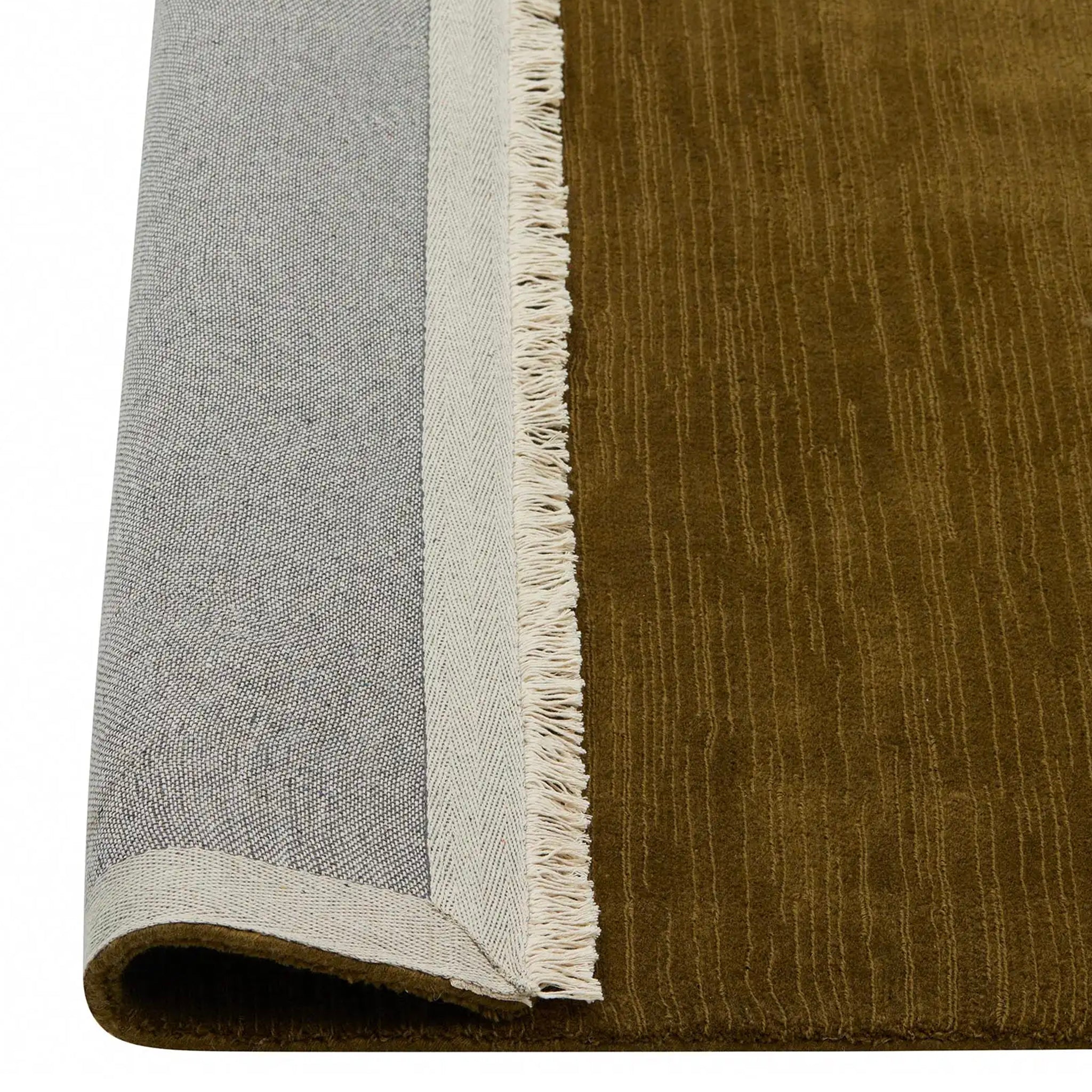 Close-up of a rug with a textured brown and gray border.