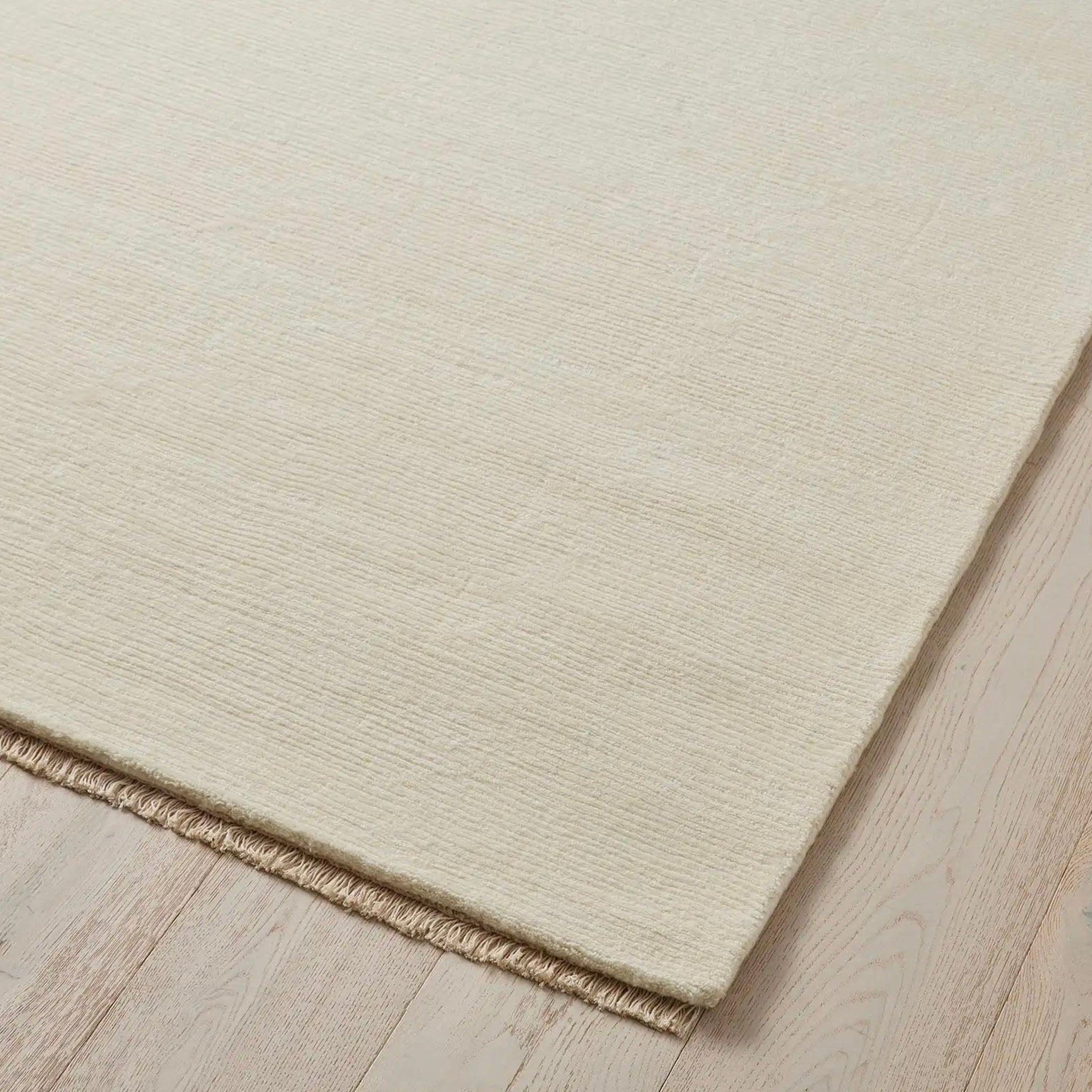 Beige rug on a wooden floor