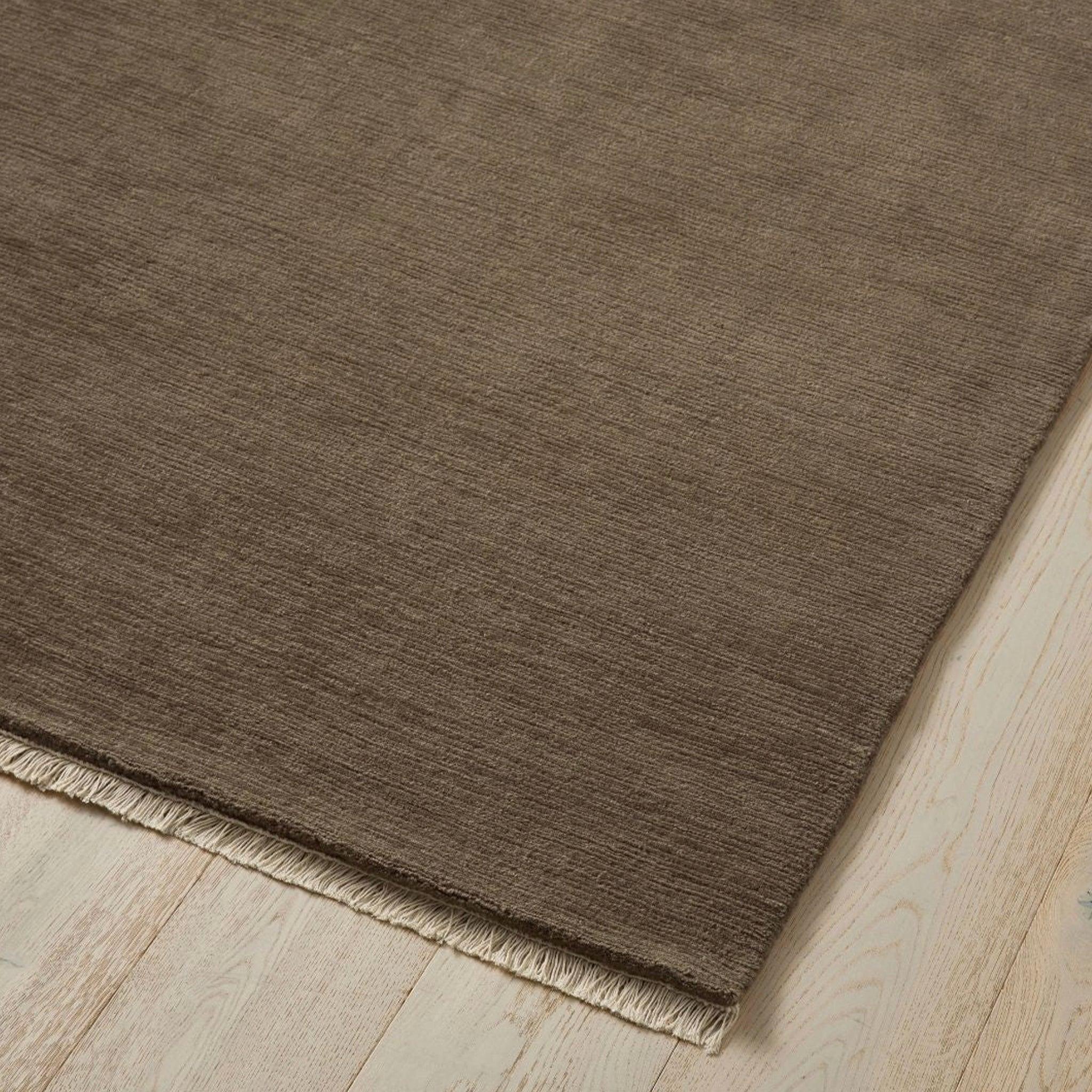 Brown rug on a wooden floor