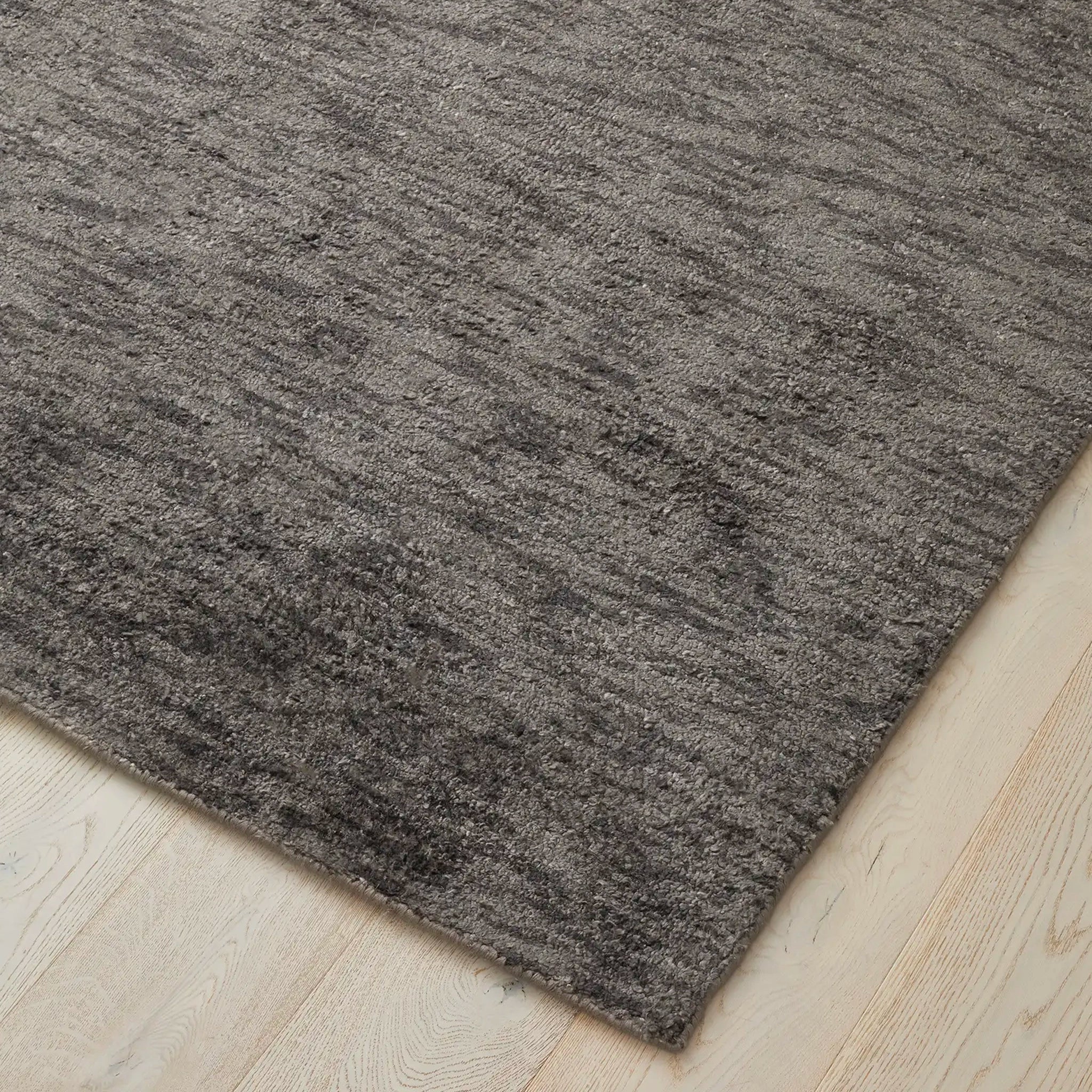Gray rug on a light wood floor