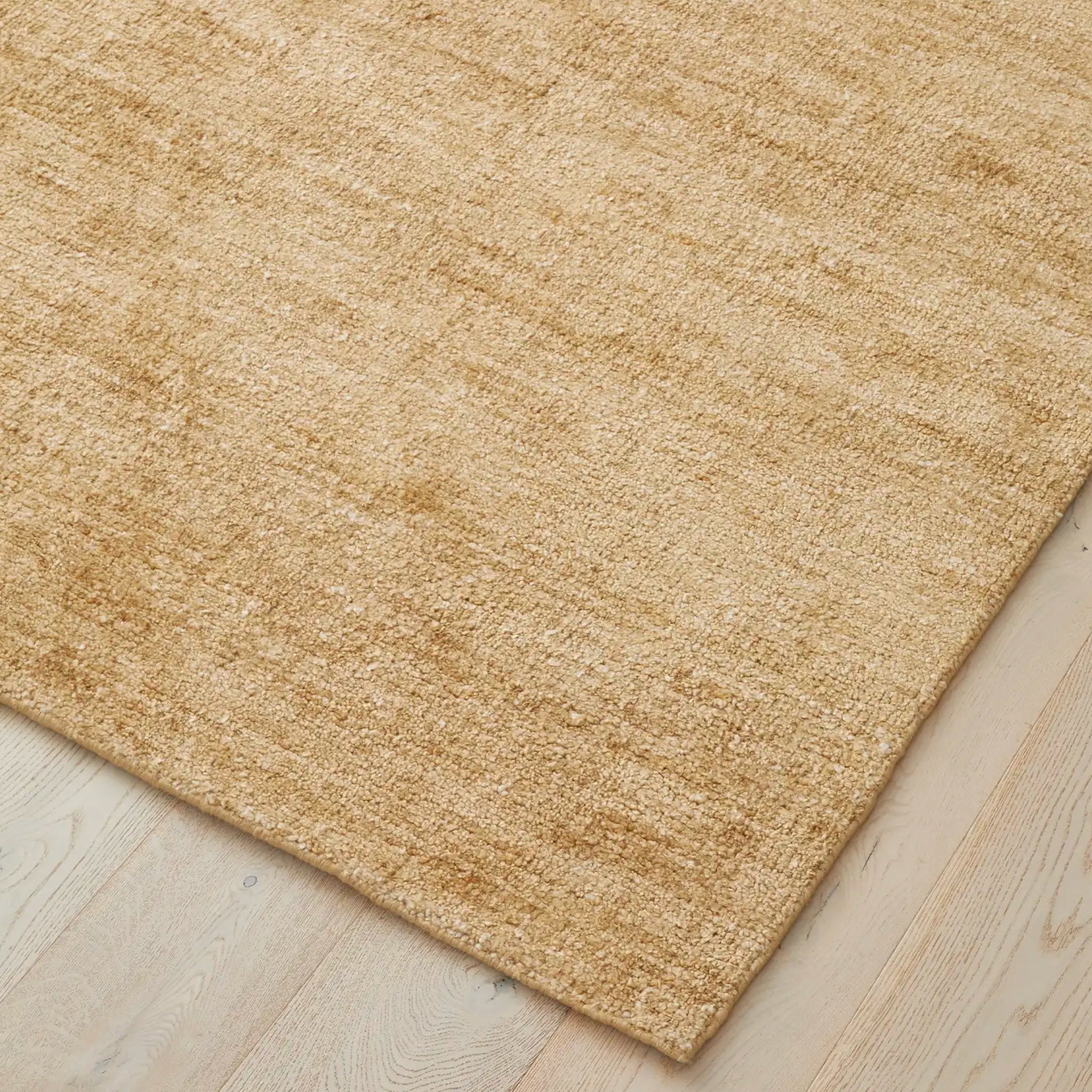 Beige rug on a wooden floor
