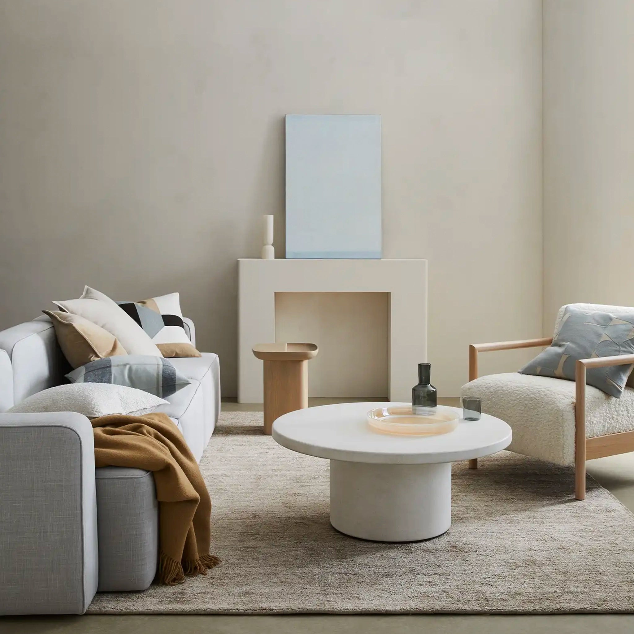 Modern living room with a sofa, coffee table, and armchair.