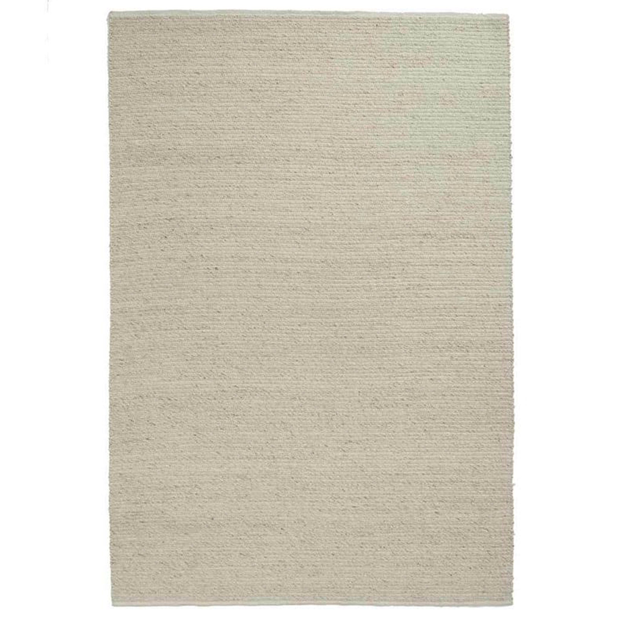 Beige area rug on a white background
