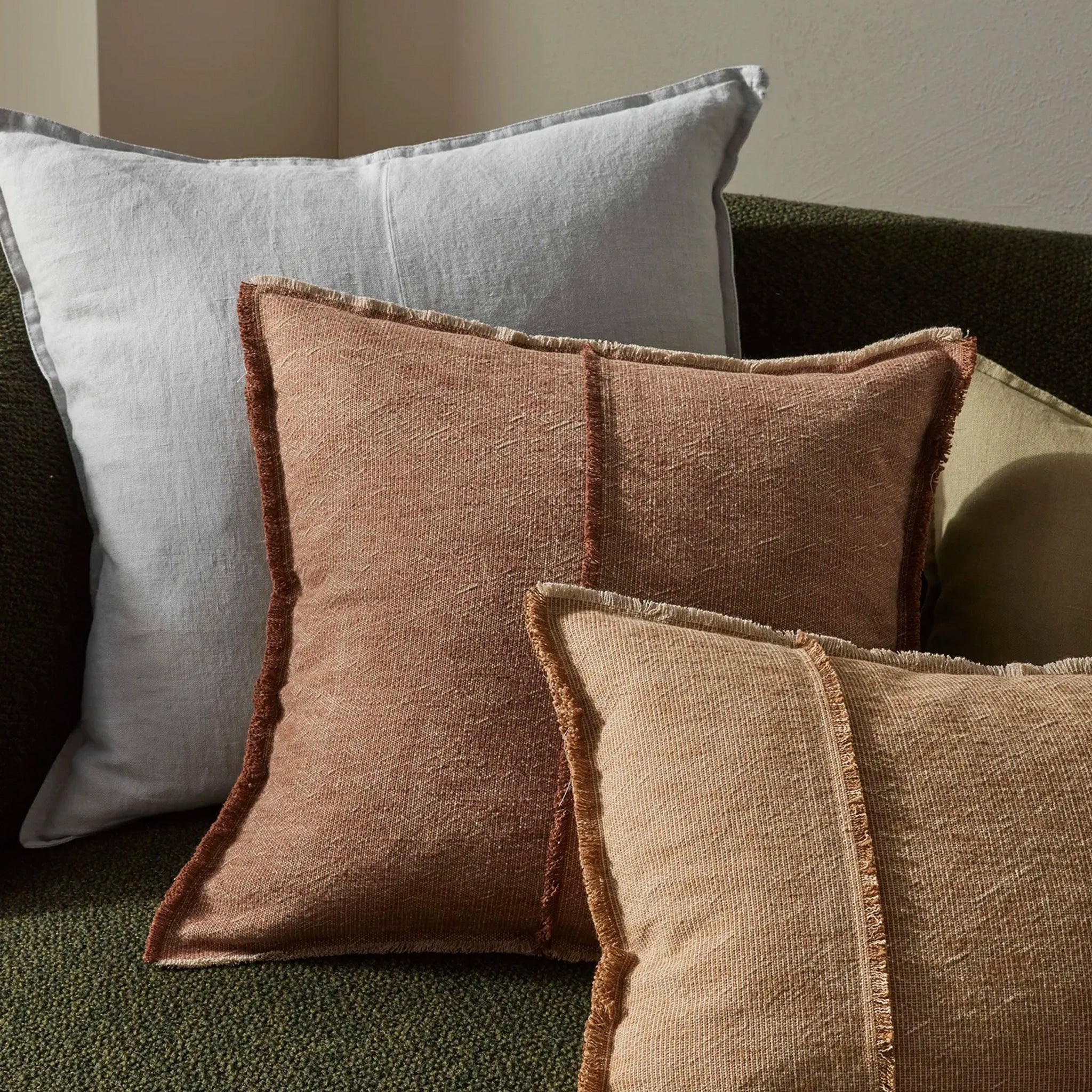 Textured pillows in brown and gray on a sofa