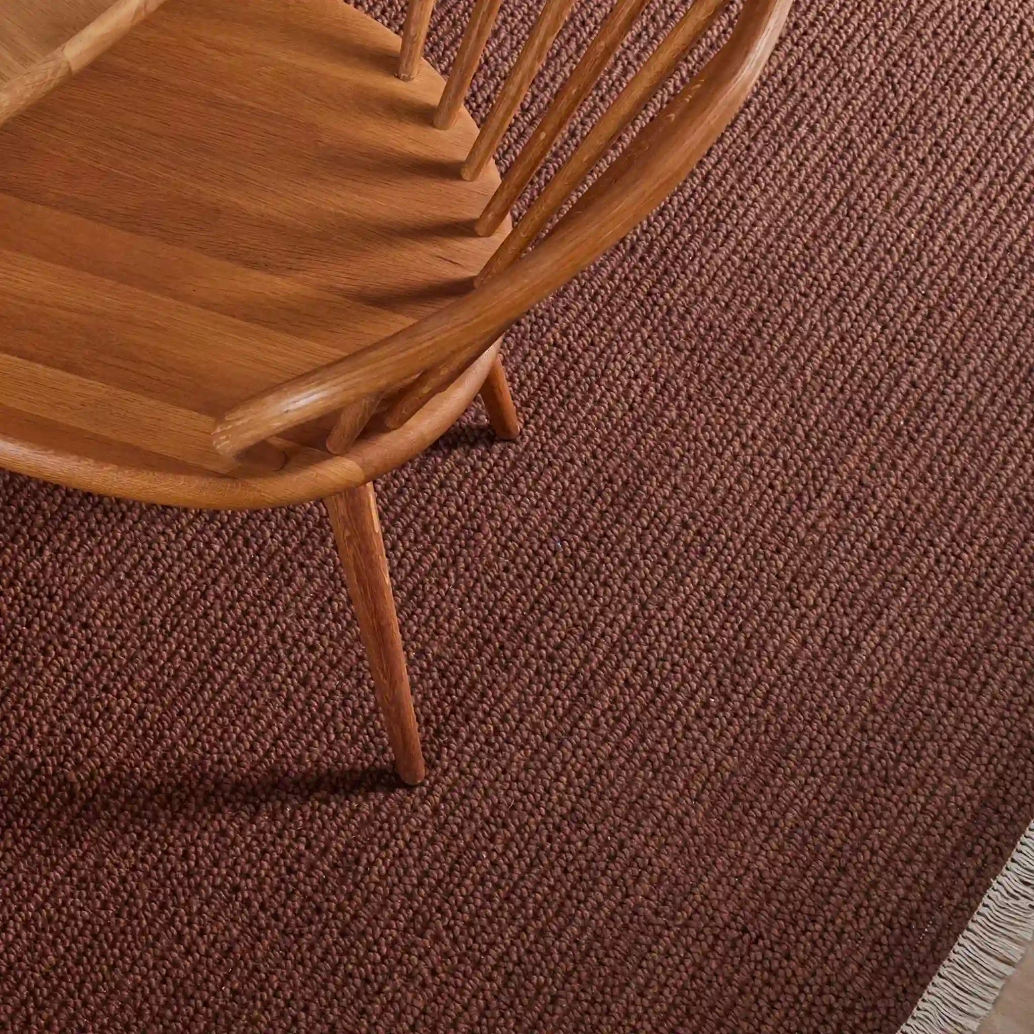 Wooden chair on a brown textured carpet
