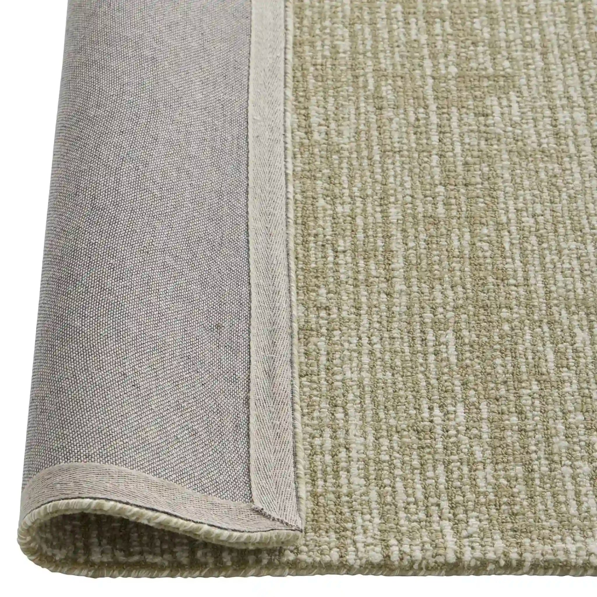 Close-up of a textured rug with a border detail