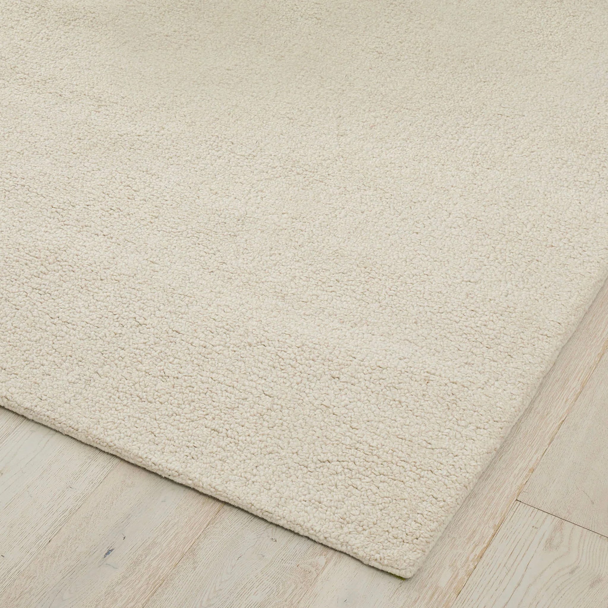 Beige rug on a wooden floor