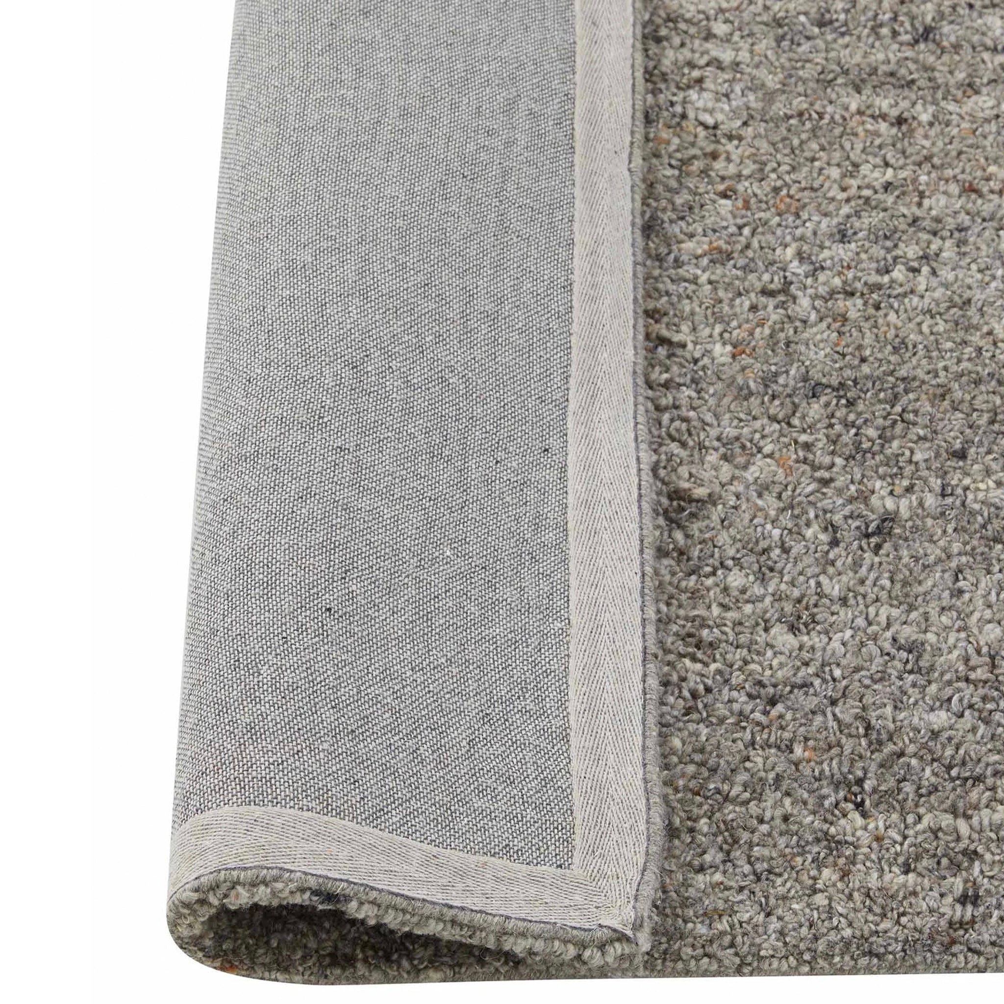 Gray rug corner with textured surface