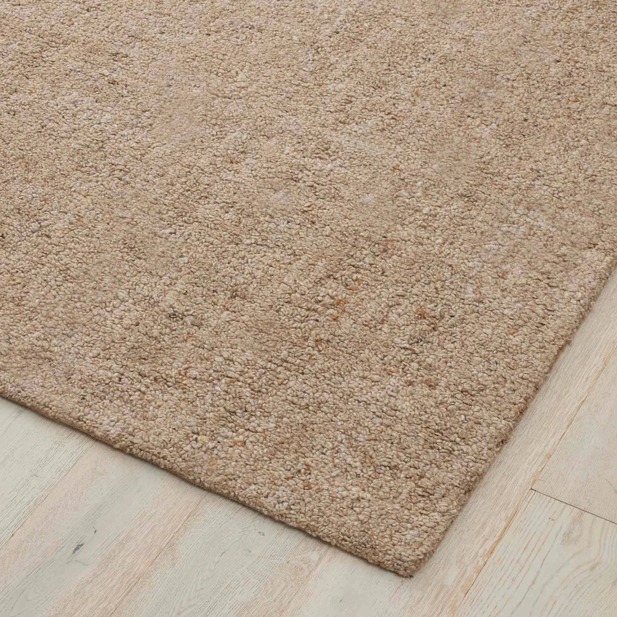 Beige rug on a wooden floor