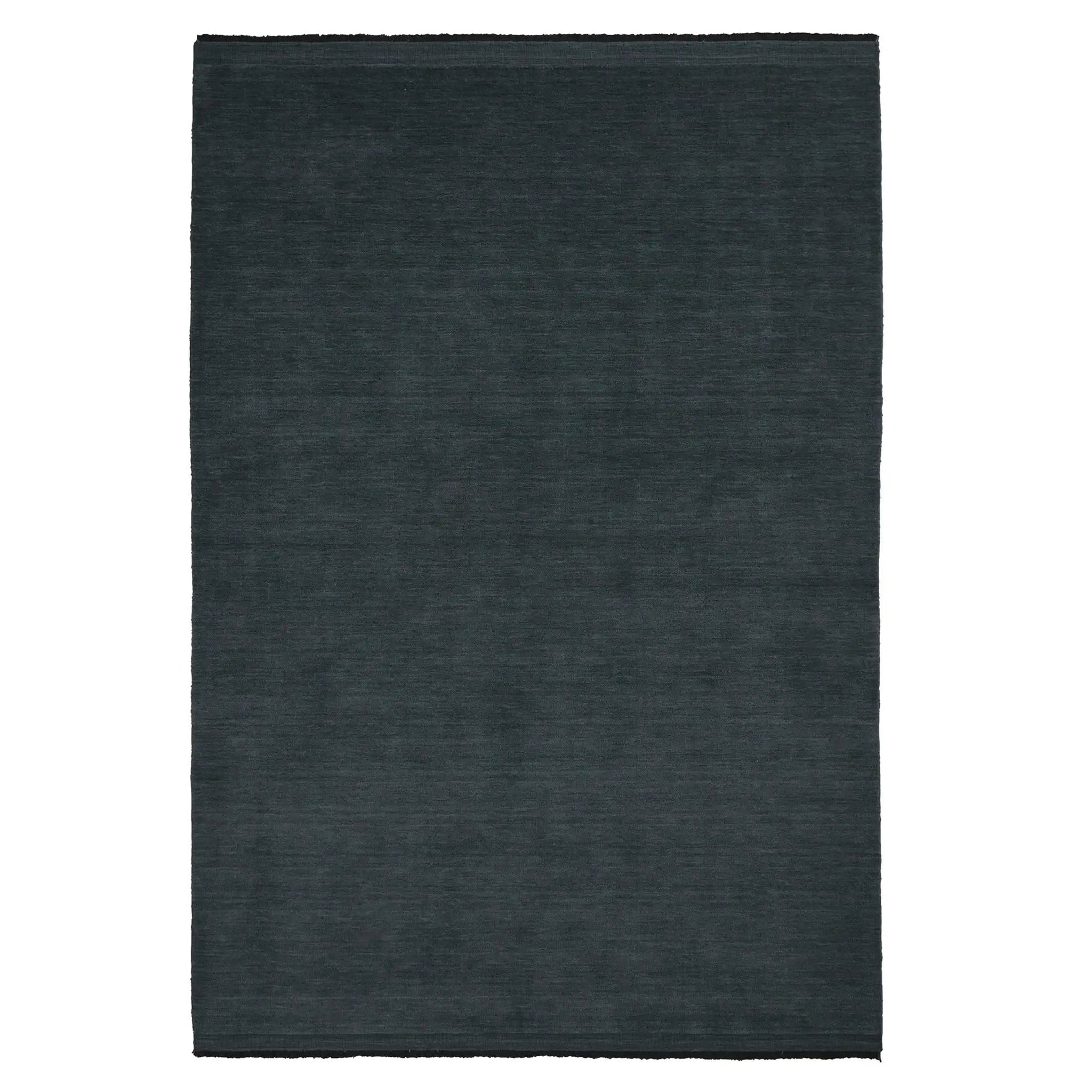 Dark gray rectangular rug on a white background