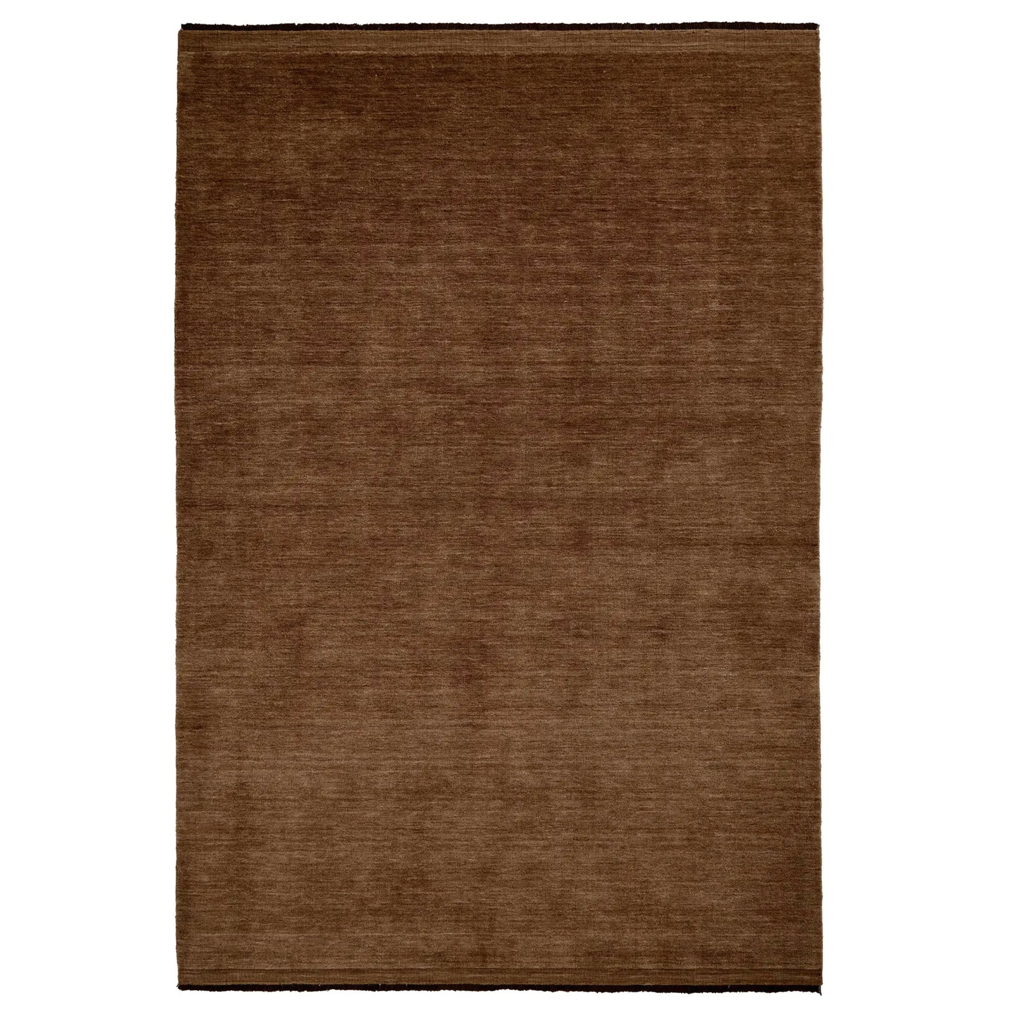 Brown rectangular rug on a white background