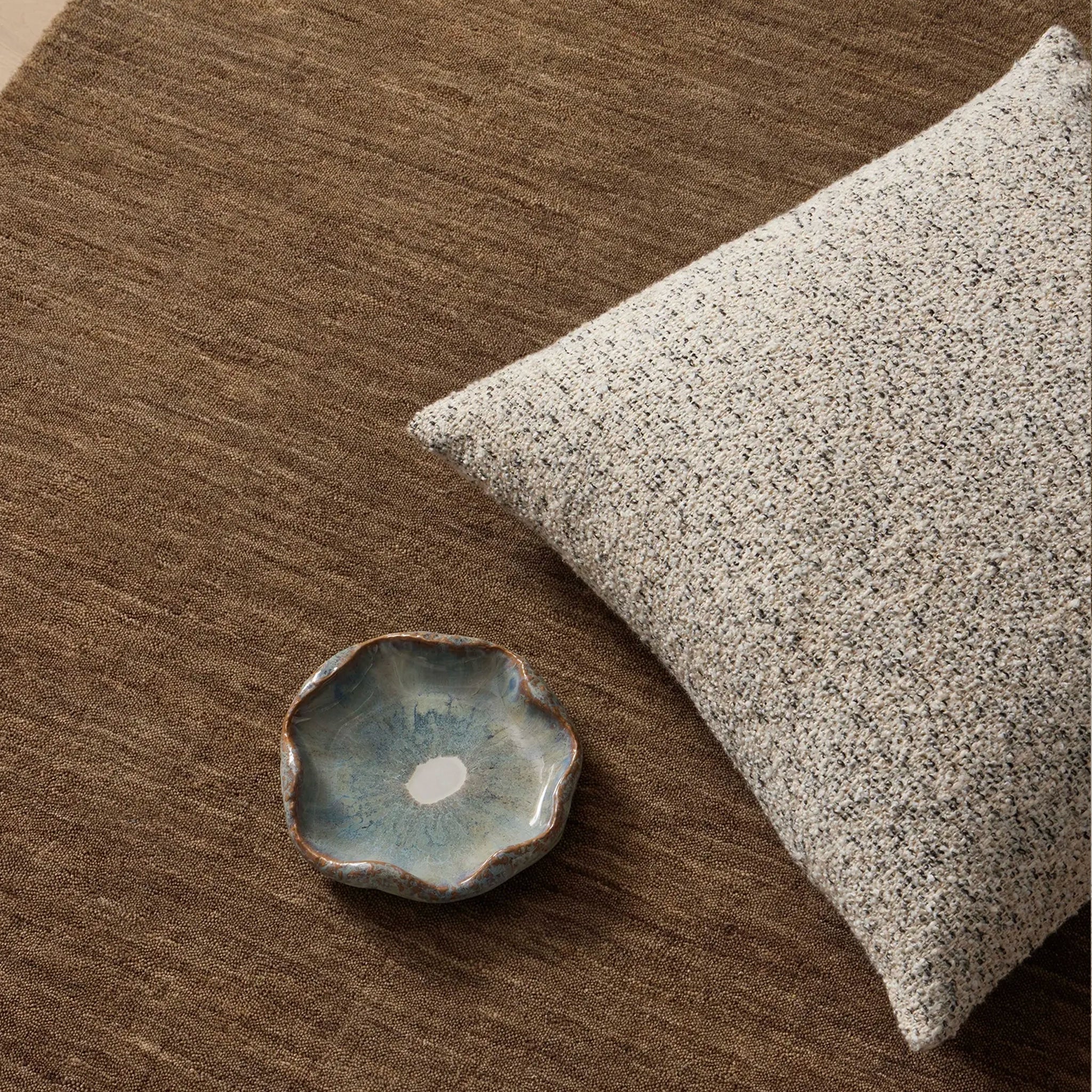 Brown rug with a cushion