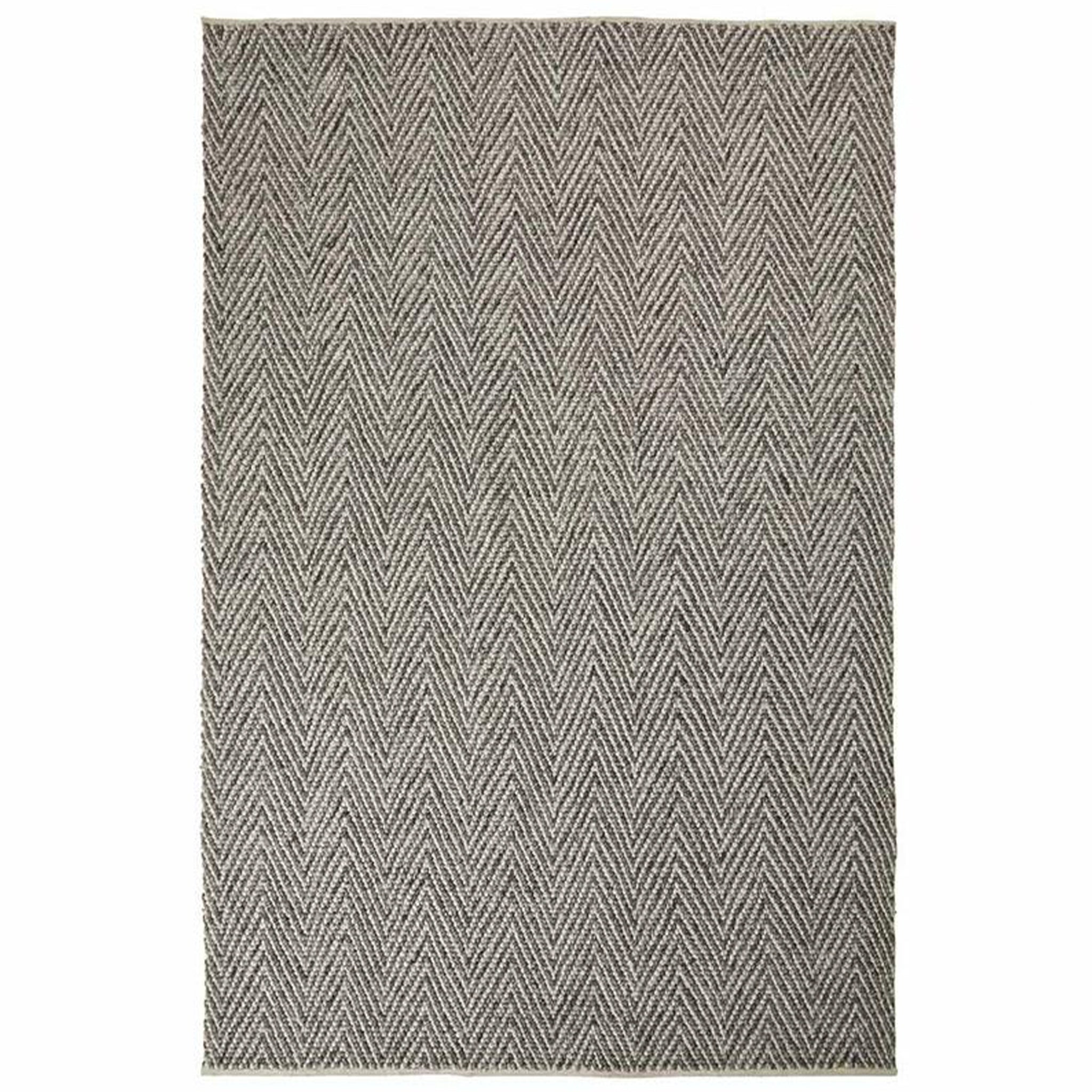 Gray and white chevron patterned rug on a white background