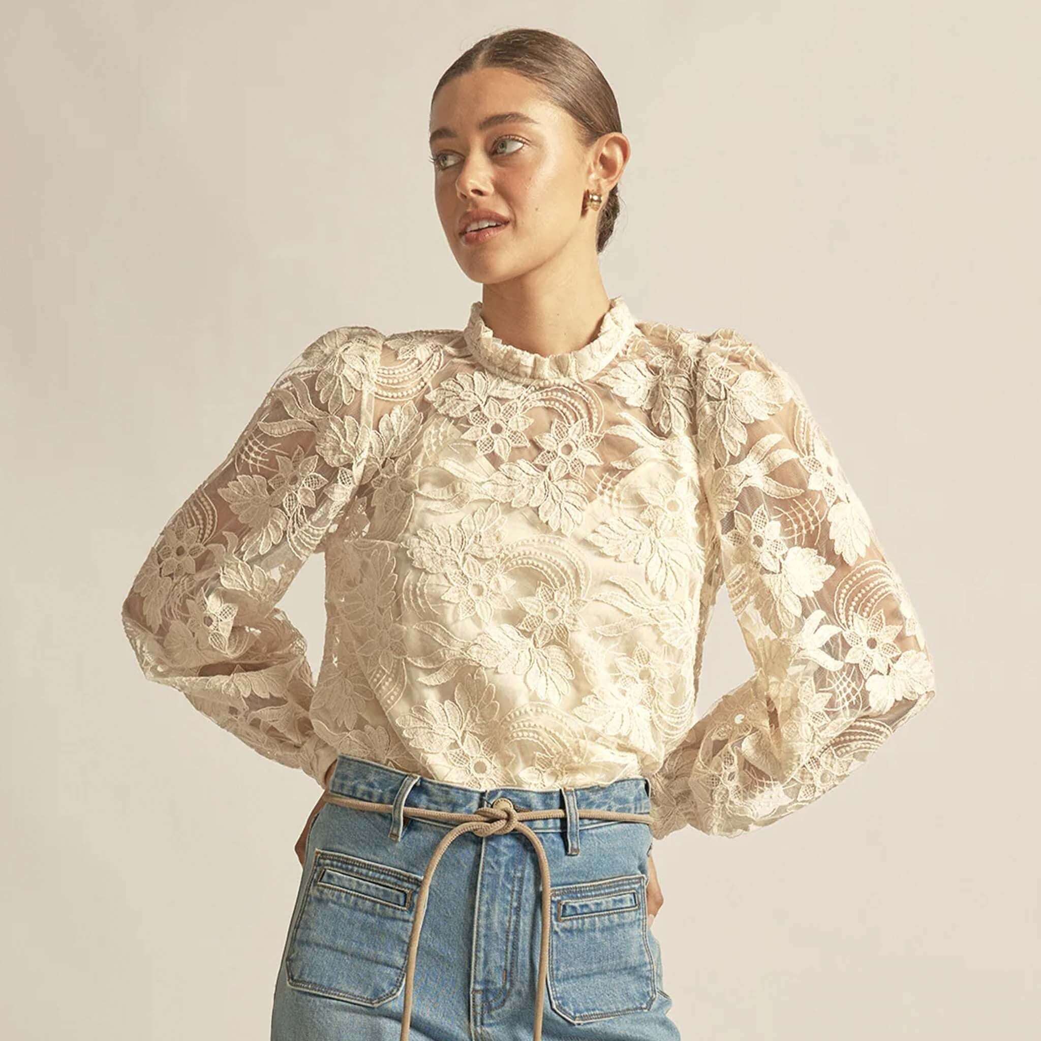 Alt Tag: Zoe Kratzmann Glint Top - Ecru lace long sleeve blouse with frill neckline and gathered shoulders on model