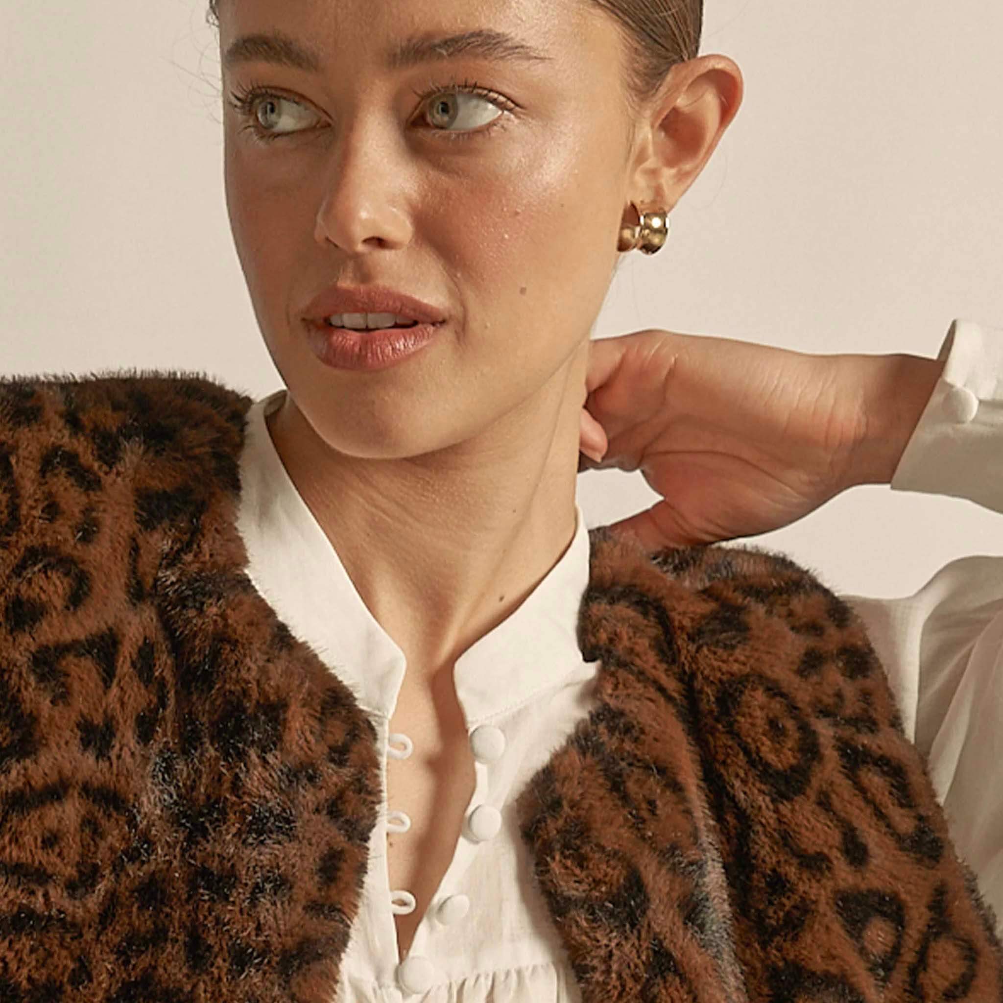 Alt Tag: Zoe Kratzmann Affirm Vest - Ocelot faux fur ocelot print vest styled over white blouse, cropped plush layering piece