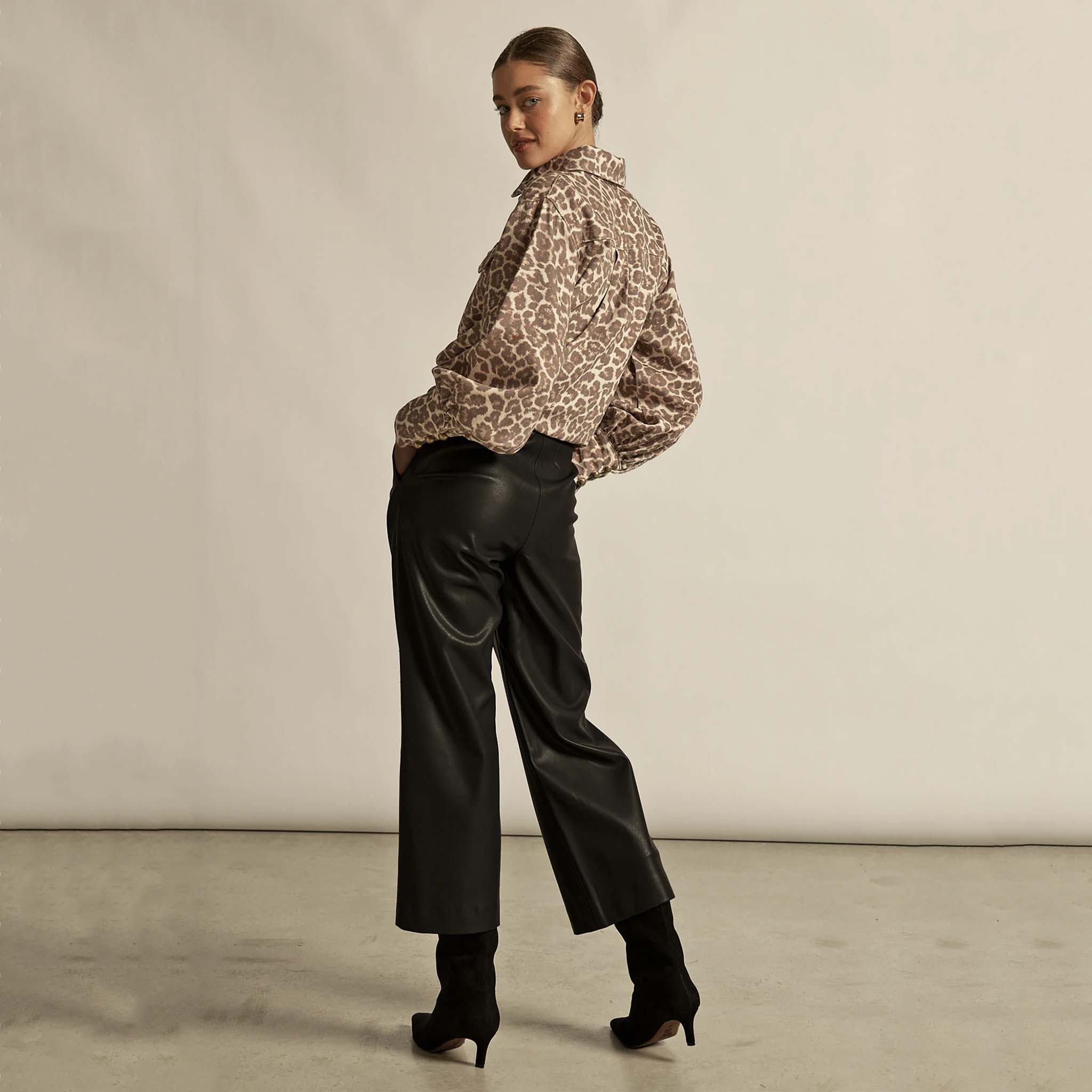 Alt Tag: Zoe Kratzmann Crest Top - Ocelot leopard print shirt styled with black wide-leg pants and heeled boots, back view