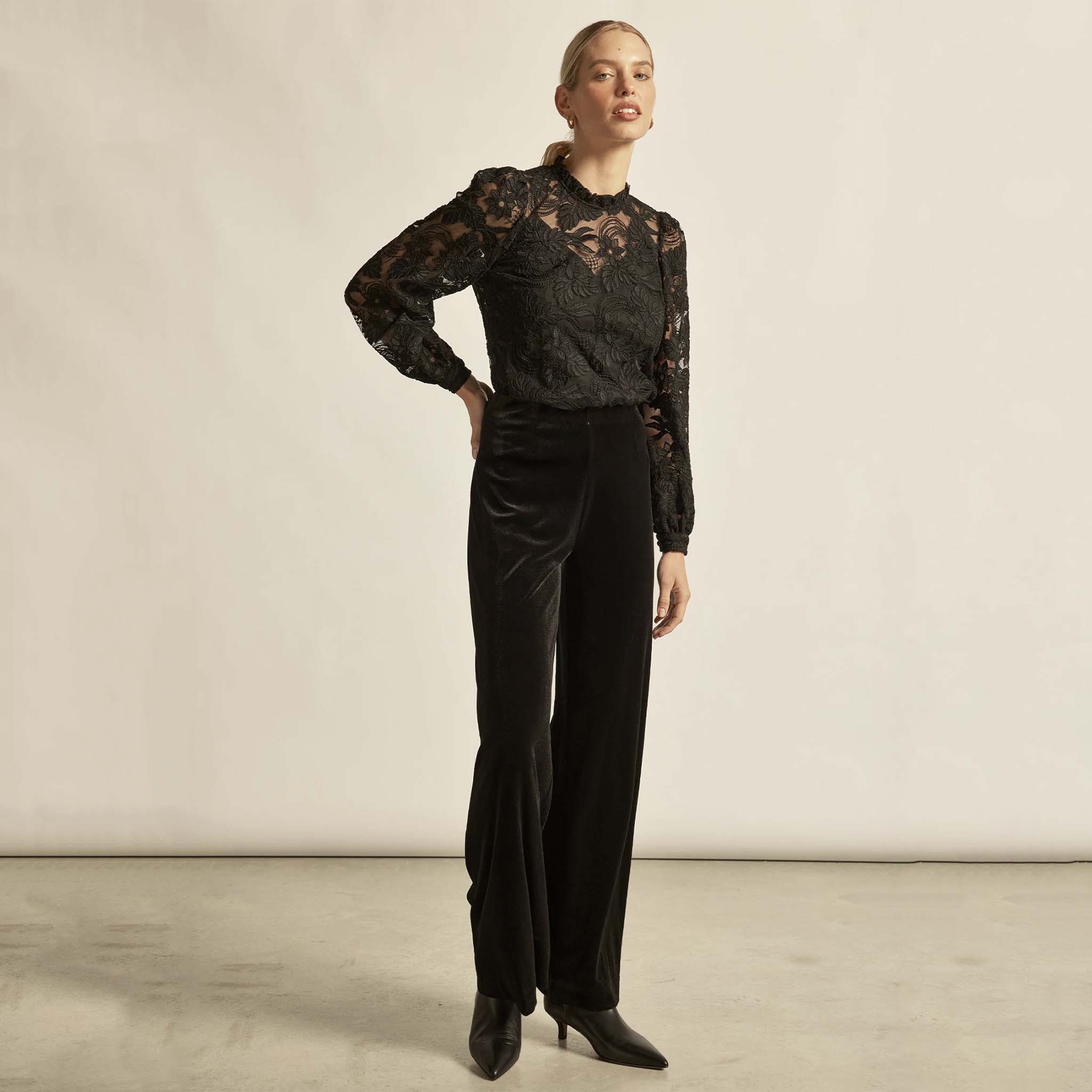 Alt Tag: Zoe Kratzmann Glint Top - Black lace long sleeve frill neckline blouse on model, elegant evening outfit