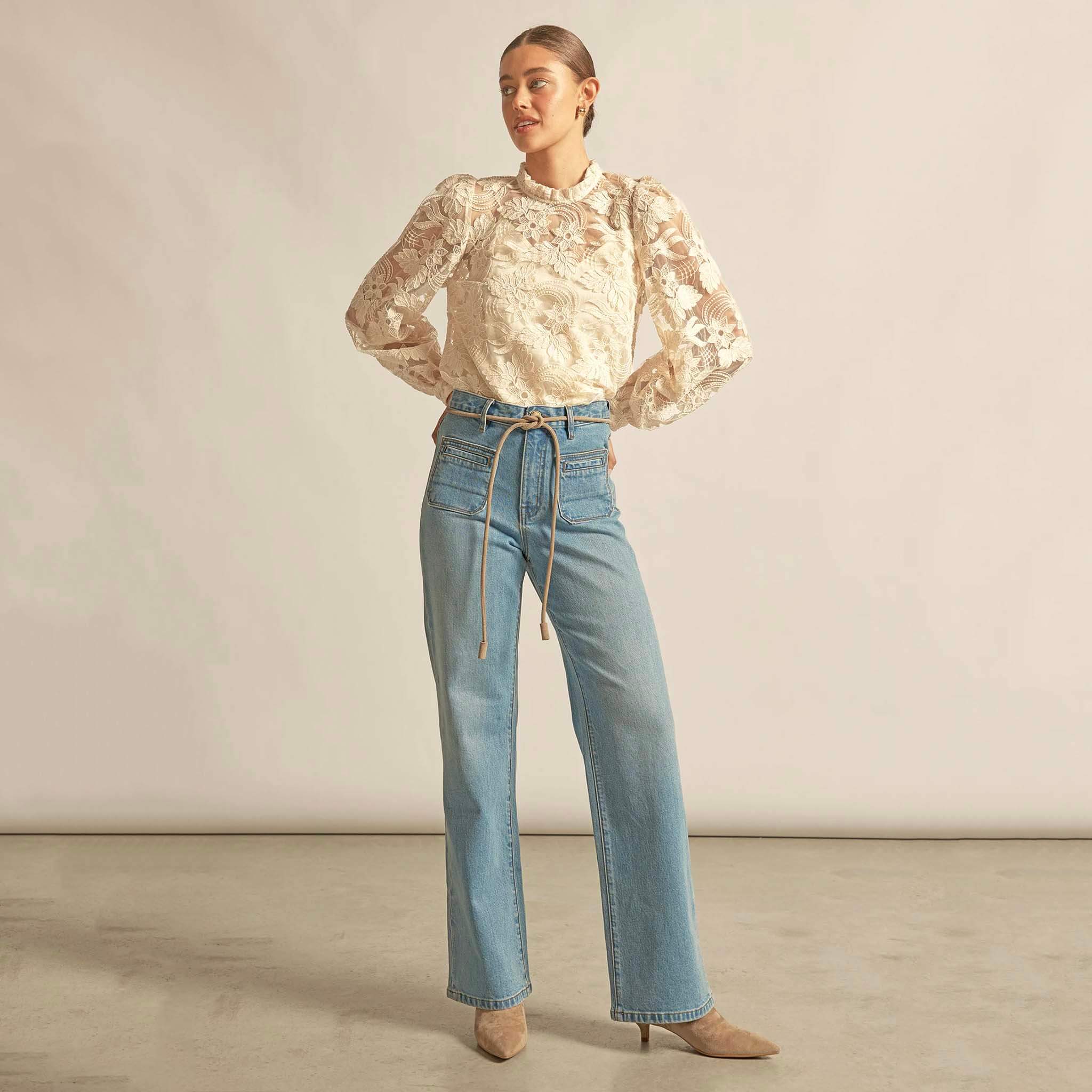 Zoe Kratzmann Glint Top - Ecru lace long sleeve blouse with frill neckline, styled with high-waist jeans and heels