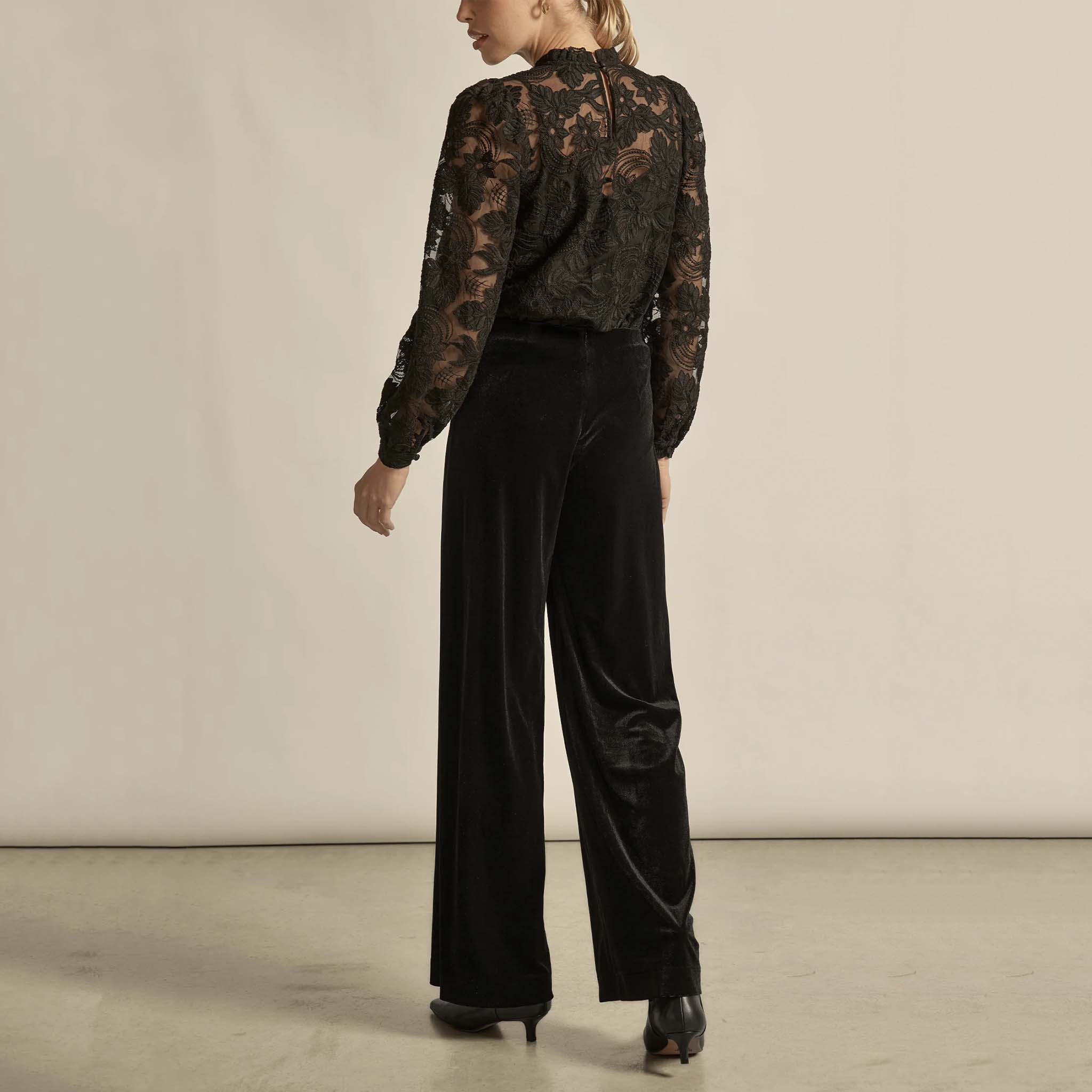 Alt Tag: Zoe Kratzmann Haven Pants - Black velvet wide-leg pants, back view styling with lace top and heels