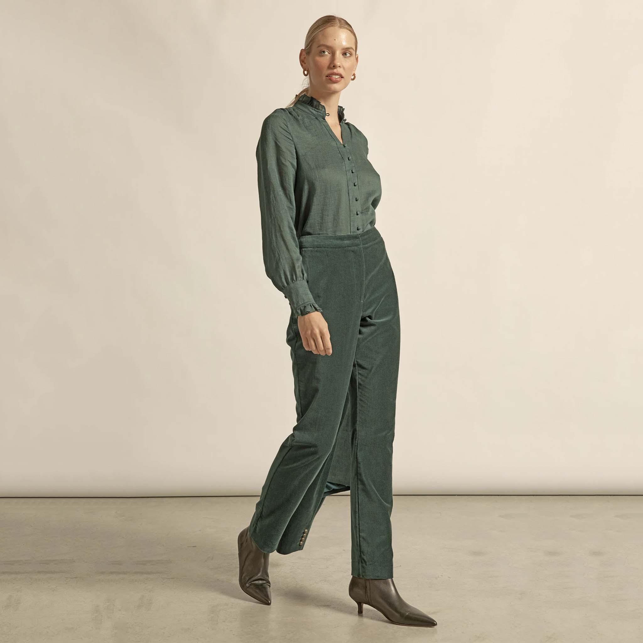 Alt Tag: Zoe Kratzmann Stir Top - Grove green ramie ruffle-neck v-neck blouse on model, long sleeves and button front
