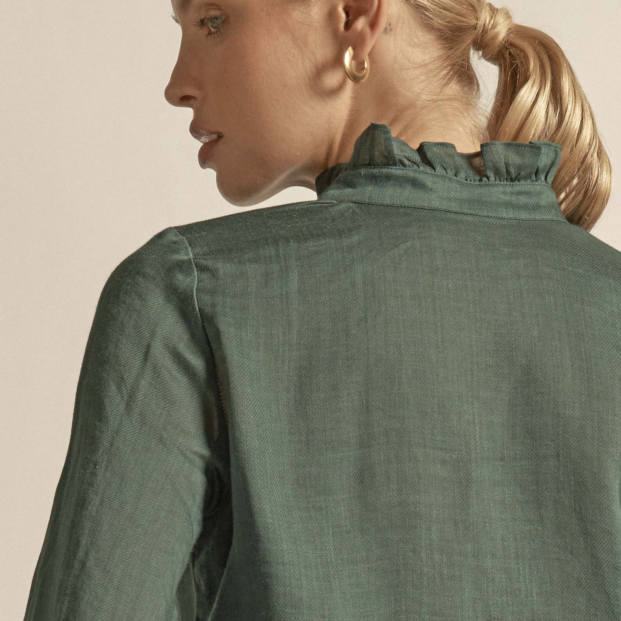 Alt Tag: Zoe Kratzmann Stir Top - Grove in ramie with ruffle neckline, back view, soft structured drape in rich green hue