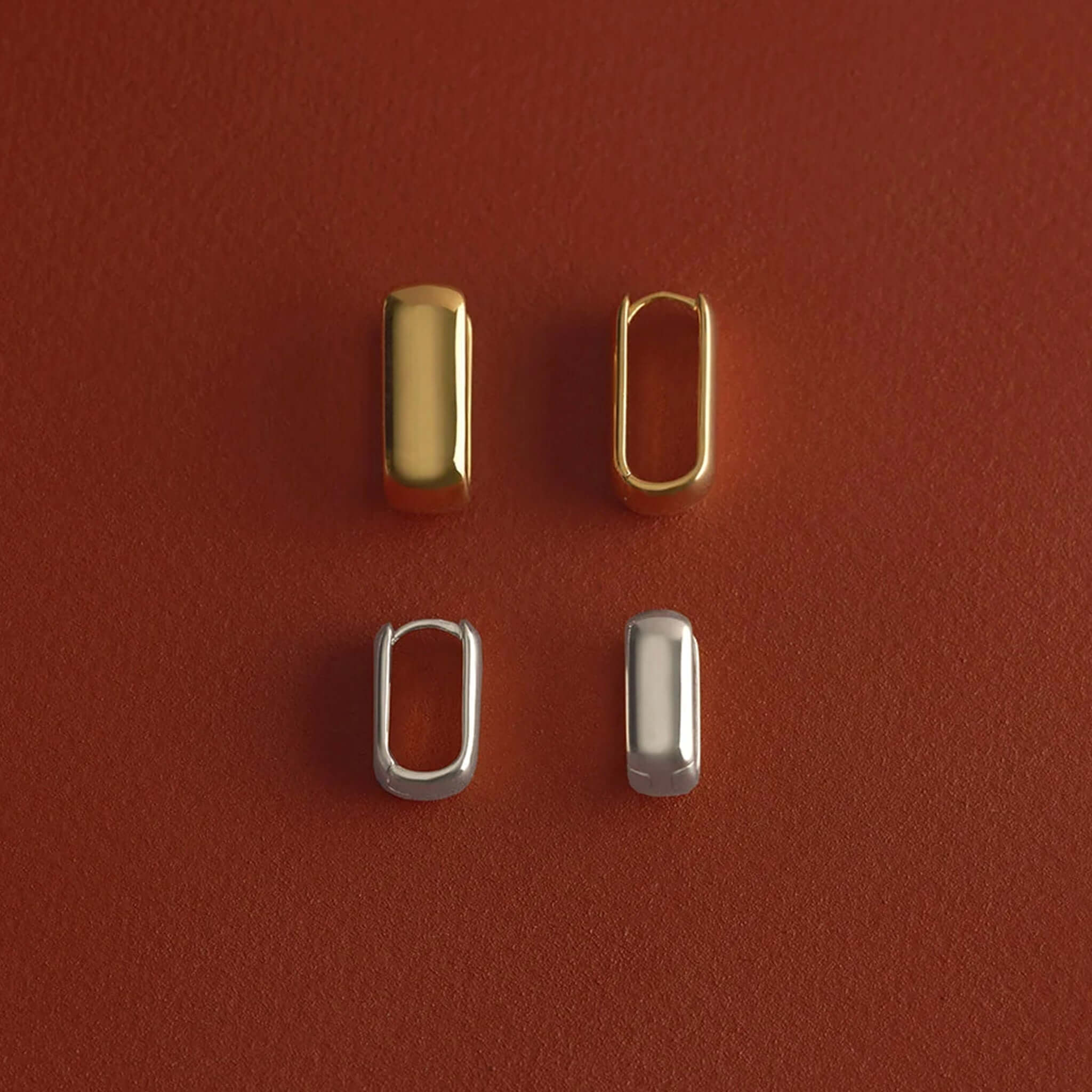 Kirstin Ash Ember Collection Symphony Hoop Earrings Small in gold and silver on a textured surface