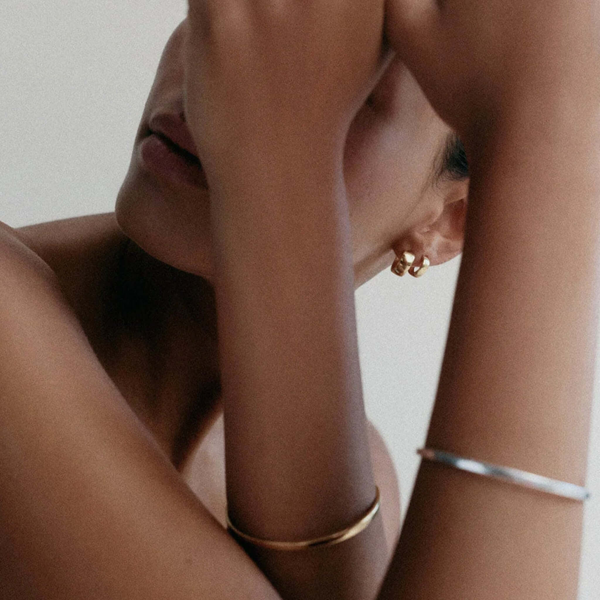 Kirstin Ash Vista Collection Vera Huggie Earrings worn by a model showcasing their polished design.