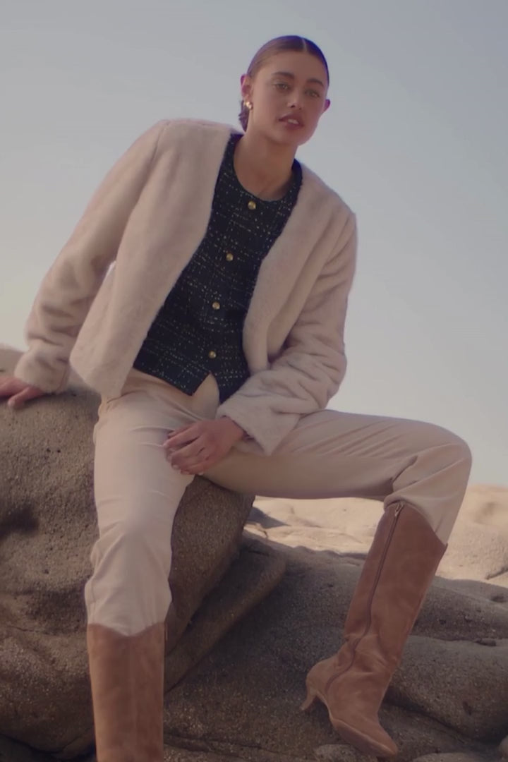 Alt Tag: Zoe Kratzmann Dune Jacket - Ecru faux fur cropped V-neck jacket on model, soft-touch winter layer styled with boots