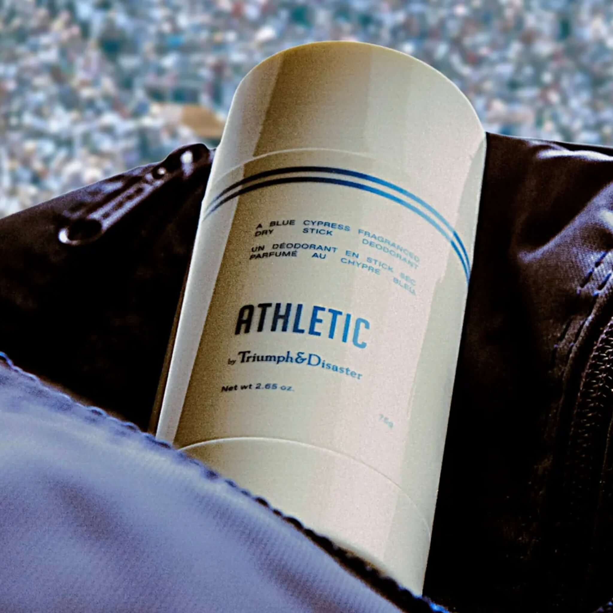 Triumph & Disaster Athletic Dry Deo Stick in a bag, showcasing natural deodorant with blue cypress fragrance.