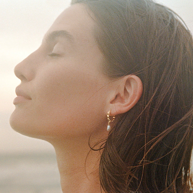 Kirstin Ash Dive In Collection - Vacation Hoop Earrings on model, gold vermeil scalloped hoop with freshwater pearl drop